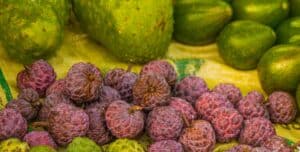 fresh round fruits on a yellow surface
